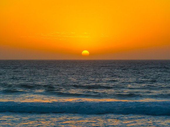 Sunrise at the Seaside with a hazy cloudless sky