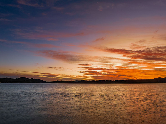 High cloud sunrise at the waterfront