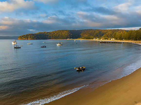 Sunrise views over the bay with boats and mountain ranges from P