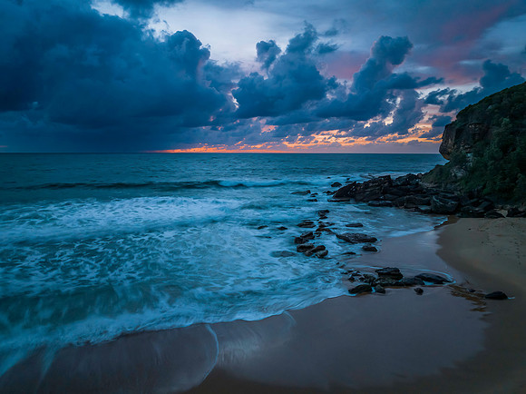 Rain clouds and sunrise at the beach