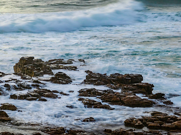 Top down sea water over rock platform in the sunrise light