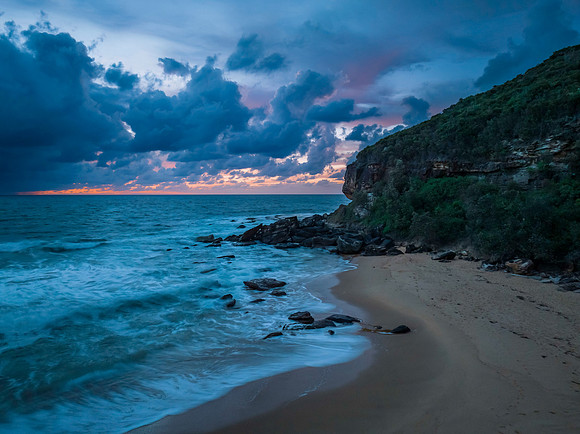Rain clouds and sunrise at the beach