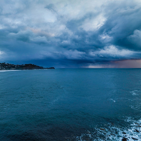 Rain clouds and storm light sunrise seascape
