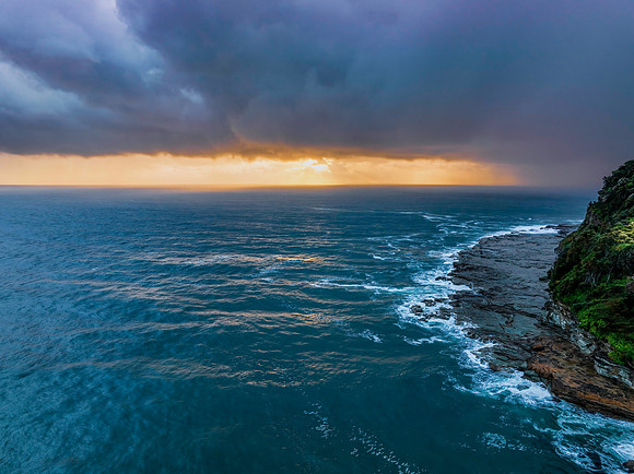 Rain clouds and storm light sunrise seascape