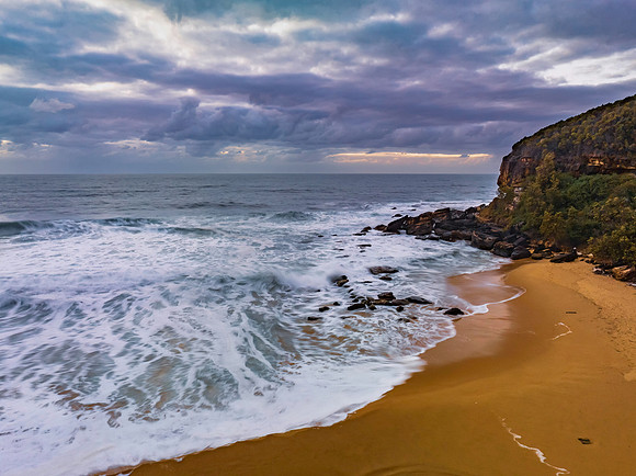 Sunrise and a cloud covered sky at the beach