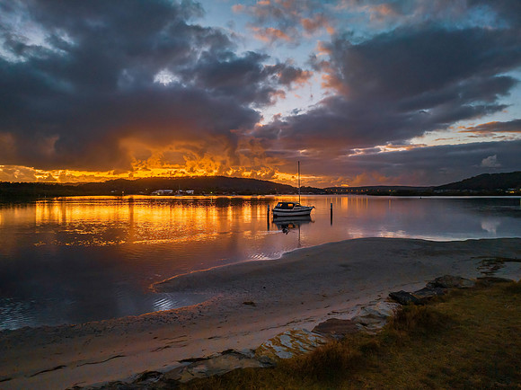 Dawn over the bay with clouds and orange highlights