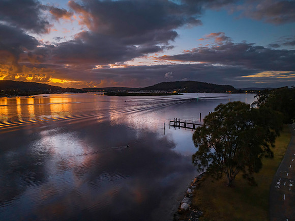 Dawn over the bay with clouds and orange highlights