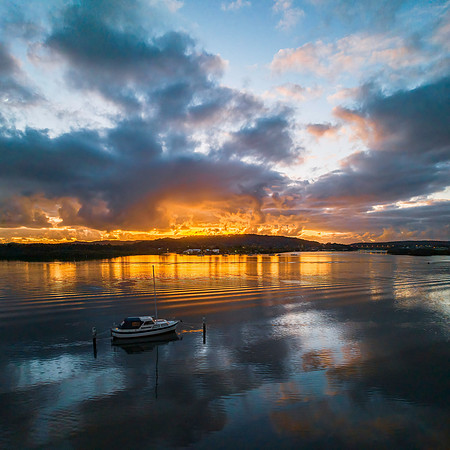 Dawn over the bay with clouds and orange highlights