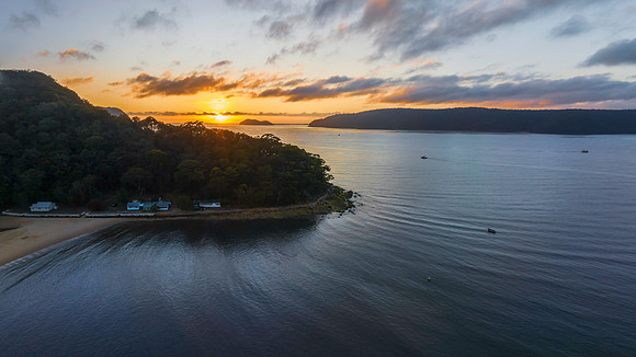 Sunrise views over the bay with boats and mountain ranges from P