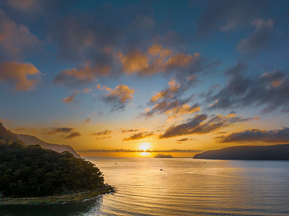 Sunrise views over the bay with boats and mountain ranges from P