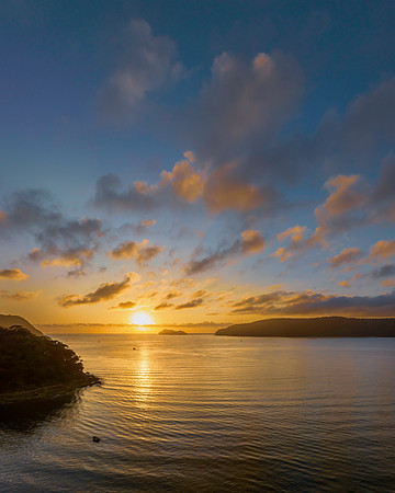 Sunrise views over the bay with boats and mountain ranges from P