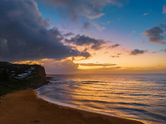 Rainy day sunrise seascape with clouds