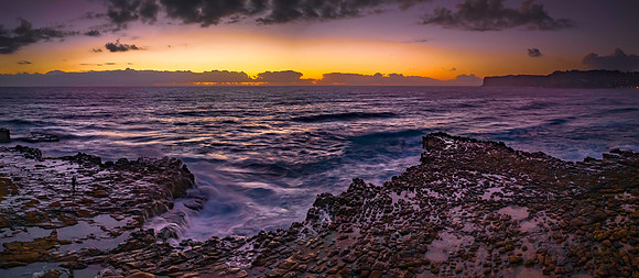 Dawn panorama over the ocean and rock platform