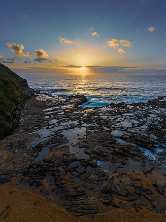 Sunrise over the ocean and rock platform