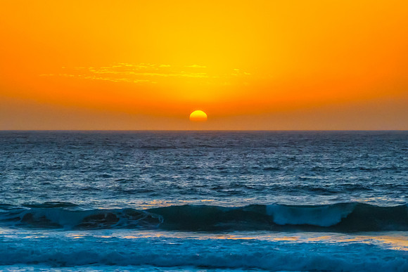 Sunrise at the Seaside with a hazy cloudless sky