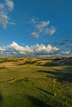 Golden hour light over the rural landscape with clouds
