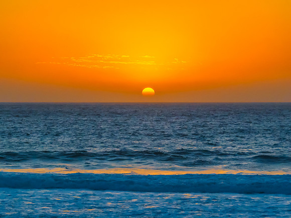 Sunrise at the Seaside with a hazy cloudless sky