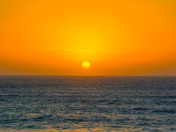 Sunrise at the Seaside with a hazy cloudless sky