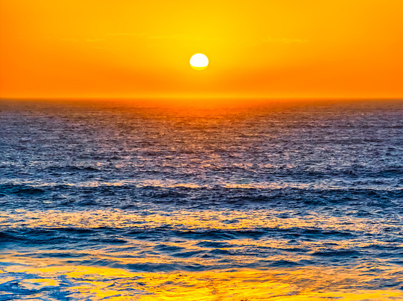 Sunrise at the Seaside with a hazy cloudless sky