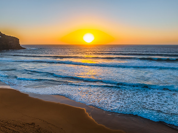 Sunrise at the Seaside with a hazy cloudless sky