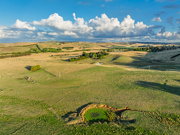 Golden hour light over the rural landscape with clouds