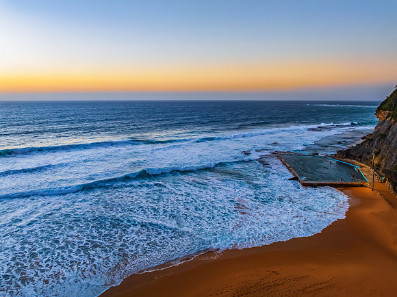 Sunrise at the Seaside with a hazy cloudless sky