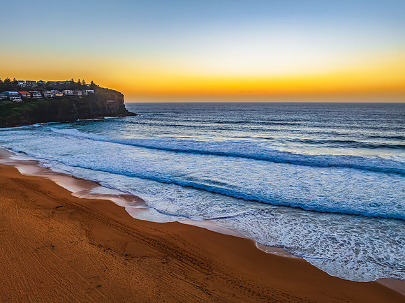Sunrise at the Seaside with a hazy cloudless sky