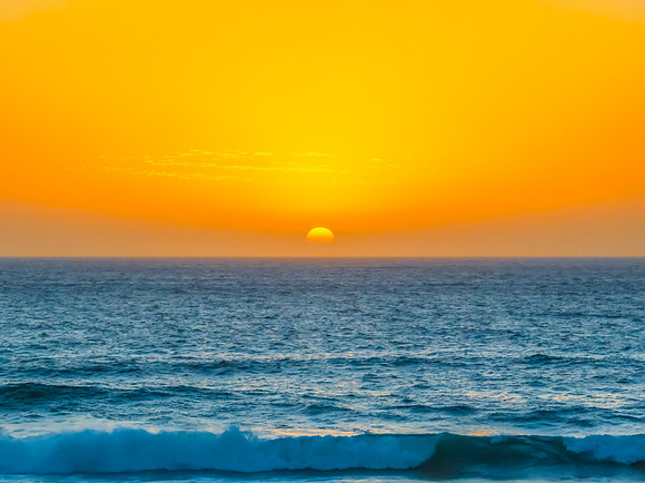 Sunrise at the Seaside with a hazy cloudless sky