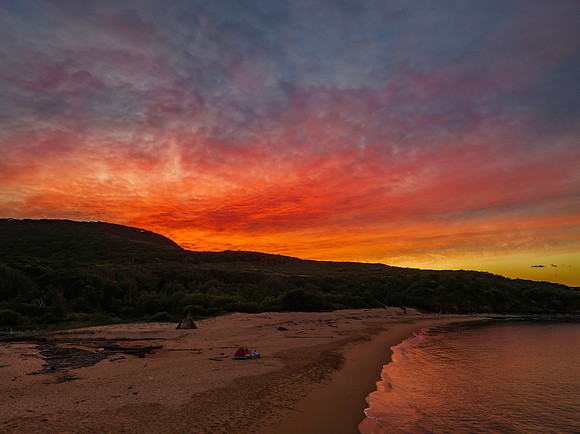 High cloud sunrise over the beach and mountain