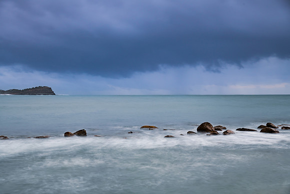 Rain clouds and storm light sunrise seascape