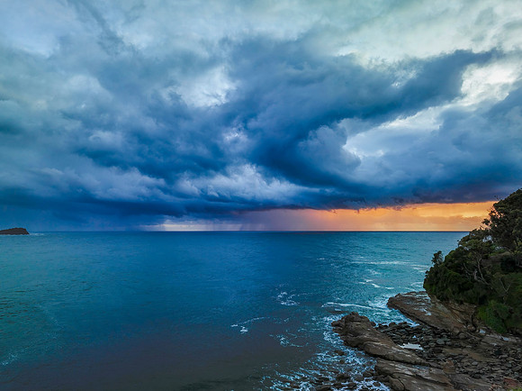 Rain clouds and storm light sunrise seascape
