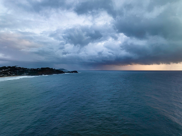 Rain clouds and storm light sunrise seascape