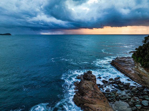 Rain clouds and storm light sunrise seascape