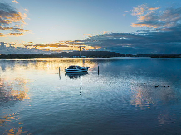 Sunrise over the bay with clouds and reflections