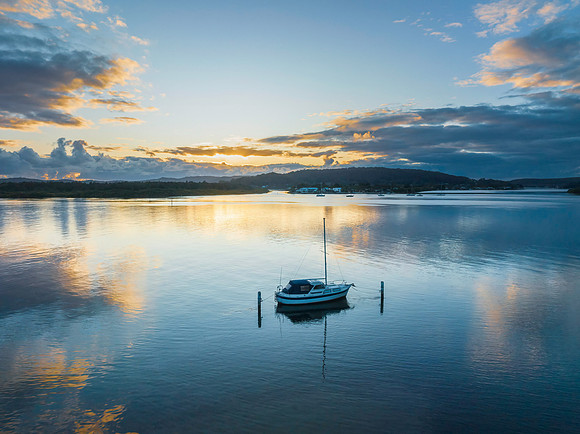Sunrise over the bay with clouds and reflections