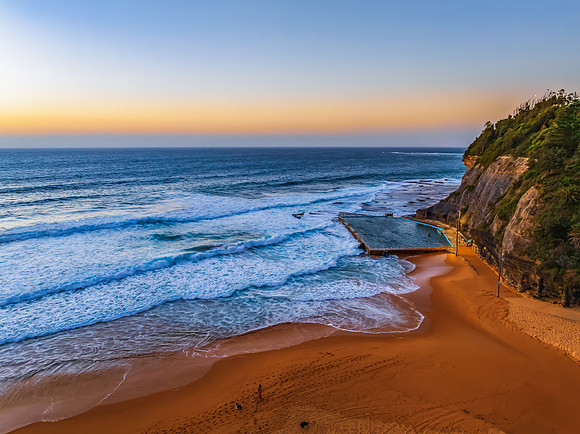 Sunrise at the Seaside with a hazy cloudless sky
