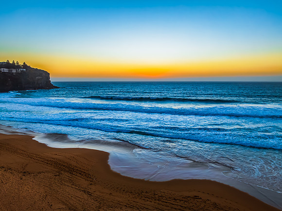 Sunrise at the Seaside with a hazy cloudless sky