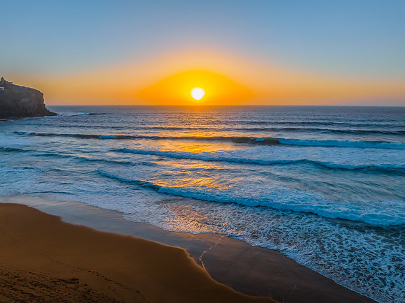 Sunrise at the Seaside with a hazy cloudless sky
