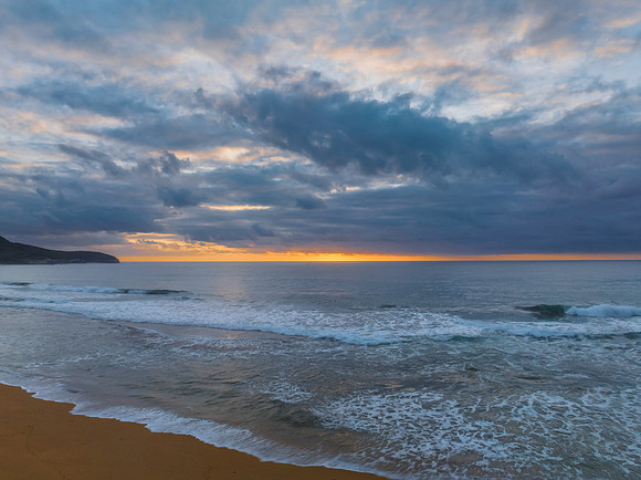 Soft sunrise seascape with clouds and colour on the horizon