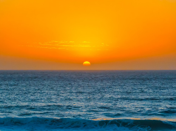 Sunrise at the Seaside with a hazy cloudless sky