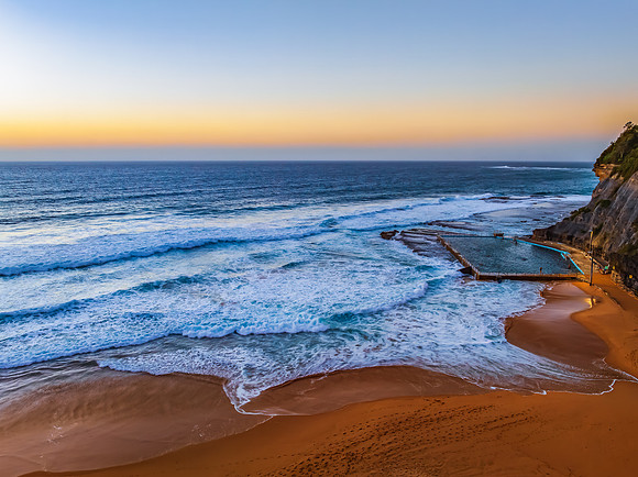 Sunrise at the Seaside with a hazy cloudless sky