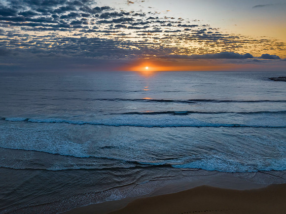 Beautiful sunrise with clouds over the ocean