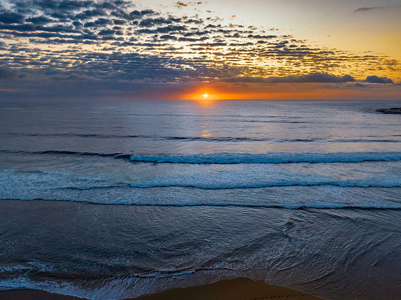 Beautiful sunrise with clouds over the ocean