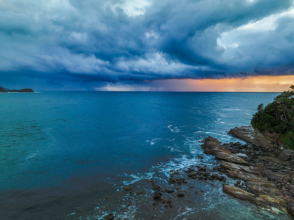 Rain clouds and storm light sunrise seascape
