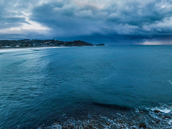 Rain clouds and storm light sunrise seascape