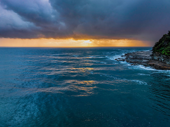 Rain clouds and storm light sunrise seascape