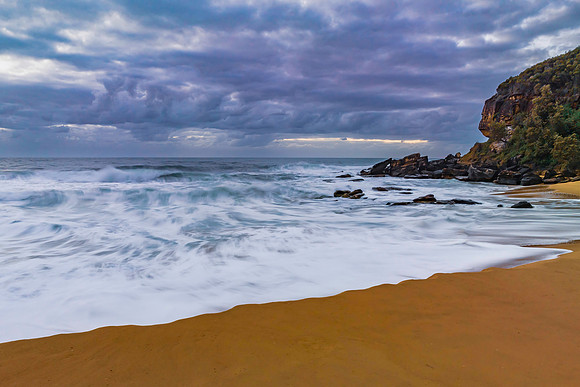 Sunrise and a cloud covered sky at the beach