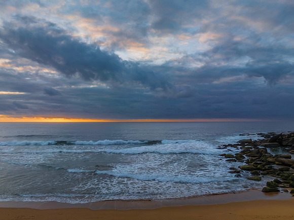 Soft sunrise seascape with clouds and colour on the horizon