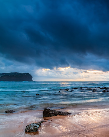 Cloud covered sunrise at the seaside