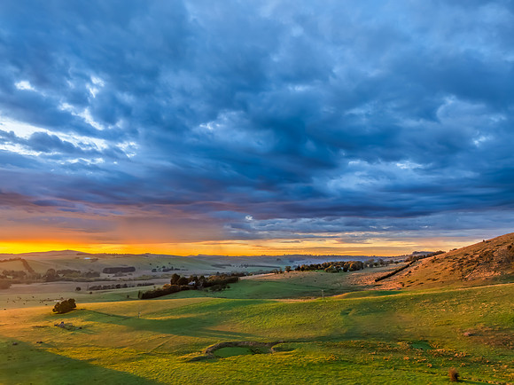 Sunrise and rain clouds over the countryside